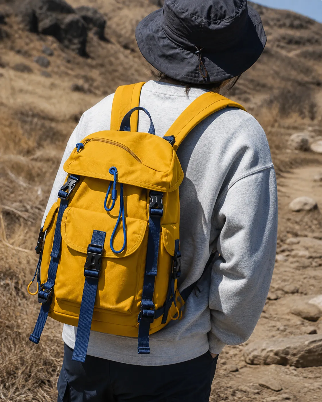 AI-generated close view of a yellow technical backpack in sunlight